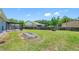 Wide backyard featuring a screened-in porch, fire pit and a fenced in yard at 3548 Galloway Oaks Ct, Lakeland, FL 33810