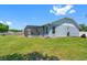 Backyard with screened-in porch, green lawn and exterior of the home at 3548 Galloway Oaks Ct, Lakeland, FL 33810