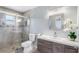 Bathroom featuring a modern vanity, large mirror, and glass enclosed shower with decorative tile accents at 3548 Galloway Oaks Ct, Lakeland, FL 33810