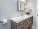 Modern bathroom features a sleek vanity with a light countertop and wooden cabinets at 3548 Galloway Oaks Ct, Lakeland, FL 33810