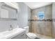 Bathroom with a modern vanity, commode, and shower stall featuring decorative tile at 3548 Galloway Oaks Ct, Lakeland, FL 33810
