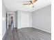 Bedroom features a ceiling fan, closet, light gray walls, and wood flooring at 3548 Galloway Oaks Ct, Lakeland, FL 33810