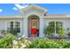 Charming home featuring a vibrant red door and well-maintained landscaping, creating an inviting entrance at 3548 Galloway Oaks Ct, Lakeland, FL 33810