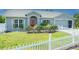 Well-maintained home with a white picket fence, lush lawn, and inviting curb appeal at 3548 Galloway Oaks Ct, Lakeland, FL 33810