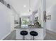 Modern kitchen featuring granite countertops, a stylish lighting fixture and seating at the bar at 3548 Galloway Oaks Ct, Lakeland, FL 33810
