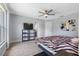 Bright main bedroom with gray wood floors, ceiling fan, and ensuite bathroom access at 3548 Galloway Oaks Ct, Lakeland, FL 33810