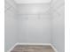 Walk-in closet with gray paint, wood floors, and wire shelving for plenty of storage space at 3548 Galloway Oaks Ct, Lakeland, FL 33810