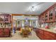 Bright dining area featuring a long wood table, chairs, and custom wood cabinets for ample storage and display at 1062 Mayflower Ave, Deltona, FL 32725