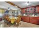 Well-lit dining area with wooden table, chairs, and custom wood cabinets, ideal for Gathering gatherings and formal dinners at 1062 Mayflower Ave, Deltona, FL 32725