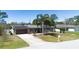 Charming single-story home featuring solar panels, a well-manicured lawn, and inviting curb appeal with tropical landscaping at 1062 Mayflower Ave, Deltona, FL 32725