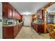 Well-equipped kitchen with extensive wooden cabinets, mosaic backsplash, modern appliances, and a functional layout at 1062 Mayflower Ave, Deltona, FL 32725