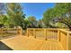 Deck with wooden railing overlooking a spacious, tree-lined yard at 4609 Creek Meadow Trl, Lakeland, FL 33810