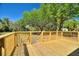 The wood deck offers a serene outdoor space with stairs to backyard at 4609 Creek Meadow Trl, Lakeland, FL 33810