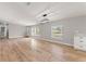 Open living room with plenty of natural light from three large windows and wood-look flooring at 4609 Creek Meadow Trl, Lakeland, FL 33810