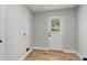 Mud room featuring wood-look flooring and an exterior door with glass panel at 4609 Creek Meadow Trl, Lakeland, FL 33810