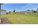 Backyard overlooking a pond with a fountain and neighborhood at 140 Jones Fish Camp Rd, Edgewater, FL 32141