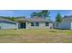 Backyard featuring a flat lawn and sliding glass doors leading into the home at 140 Jones Fish Camp Rd, Edgewater, FL 32141
