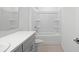Bright bathroom featuring a shower-tub combo with white tile and large vanity with a light countertop at 140 Jones Fish Camp Rd, Edgewater, FL 32141