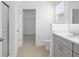 Bathroom featuring a white sink and vanity, tile floors, and a doorway to a walk-in closet at 140 Jones Fish Camp Rd, Edgewater, FL 32141