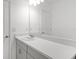 Bathroom featuring white walls and vanity with a light countertop, a large mirror, and modern fixtures at 140 Jones Fish Camp Rd, Edgewater, FL 32141