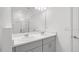 Bathroom featuring dual sinks, white cabinets, granite countertops, and a framed mirror at 140 Jones Fish Camp Rd, Edgewater, FL 32141