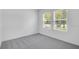 Bright bedroom with large window and gray carpet at 140 Jones Fish Camp Rd, Edgewater, FL 32141