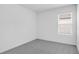Bedroom features neutral gray carpet and a window at 140 Jones Fish Camp Rd, Edgewater, FL 32141