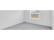 Bedroom features neutral gray carpet and a window at 140 Jones Fish Camp Rd, Edgewater, FL 32141