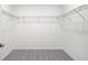 Walk-in closet featuring neutral gray carpet and white walls with coated wire shelving at 140 Jones Fish Camp Rd, Edgewater, FL 32141