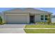 Charming single-story home featuring an attached two-car garage and well-maintained lawn at 140 Jones Fish Camp Rd, Edgewater, FL 32141