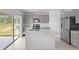 Contemporary kitchen boasts stainless steel appliances, an island, and modern gray cabinets at 140 Jones Fish Camp Rd, Edgewater, FL 32141