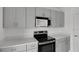 This kitchen has sleek countertops, grey cabinets, and modern stainless steel appliances at 140 Jones Fish Camp Rd, Edgewater, FL 32141