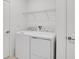 White laundry room featuring modern washer and dryer units and a wire shelf above at 140 Jones Fish Camp Rd, Edgewater, FL 32141