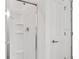 White shower featuring a sliding glass door and built-in shelving and shower head at 140 Jones Fish Camp Rd, Edgewater, FL 32141