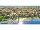 Backyard lake view featuring well manicured lawn and pool, perfect for relaxing and entertaining at 10837 Versailles Blvd, Clermont, FL 34711