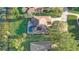 Stunning aerial view of a private pool and lush tropical foliage surrounding a well-maintained home at 10837 Versailles Blvd, Clermont, FL 34711