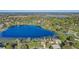 Wide aerial shot of a home nestled among a sprawling lakefront community at 10837 Versailles Blvd, Clermont, FL 34711