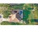 Aerial shot of a home featuring a screened pool, lush landscaping, and an inviting backyard oasis at 10837 Versailles Blvd, Clermont, FL 34711