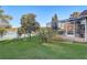 Well-maintained backyard showcasing a screened-in patio with tranquil views of the adjacent lake at 10837 Versailles Blvd, Clermont, FL 34711