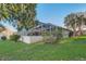 Spacious backyard featuring a screened-in patio and views of the lake, creating a serene outdoor retreat at 10837 Versailles Blvd, Clermont, FL 34711