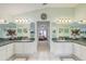 Bright bathroom featuring dual vanities, sinks, granite countertops, and a view into the adjacent room at 10837 Versailles Blvd, Clermont, FL 34711