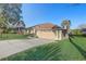 Charming home with a well-manicured lawn, spacious driveway, and attached two car garage at 10837 Versailles Blvd, Clermont, FL 34711