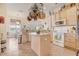 Modern kitchen with stainless appliances and granite countertops overlooks a breakfast nook and living area at 10837 Versailles Blvd, Clermont, FL 34711