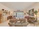 Comfortable living room features neutral tones, glass table and a sliding glass door overlooking the lanai at 10837 Versailles Blvd, Clermont, FL 34711