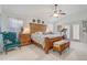 Large main bedroom with a king-size bed, wooden furniture, and ceiling fan at 10837 Versailles Blvd, Clermont, FL 34711