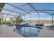 Screened-in pool offers a beautiful view of the lake at 10837 Versailles Blvd, Clermont, FL 34711