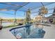 Inviting screened-in pool overlooking a tranquil lake, perfect for swimming and enjoying waterfront views at 10837 Versailles Blvd, Clermont, FL 34711