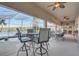 Relaxing poolside seating area under a screened enclosure, perfect for enjoying the serene lake view at 10837 Versailles Blvd, Clermont, FL 34711