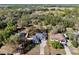 Aerial view shows property lines of a home with a large yard, mature trees, and surrounding neighborhood at 3688 Hurlbut Cir, Lake Wales, FL 33898