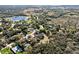 Aerial view of a neighborhood with lush greenery, scattered homes, and serene lakes in a peaceful setting at 3688 Hurlbut Cir, Lake Wales, FL 33898